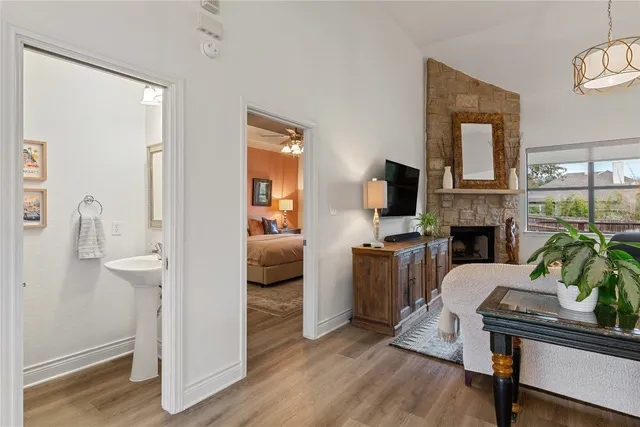 a living room with furniture a fireplace and a flat screen tv