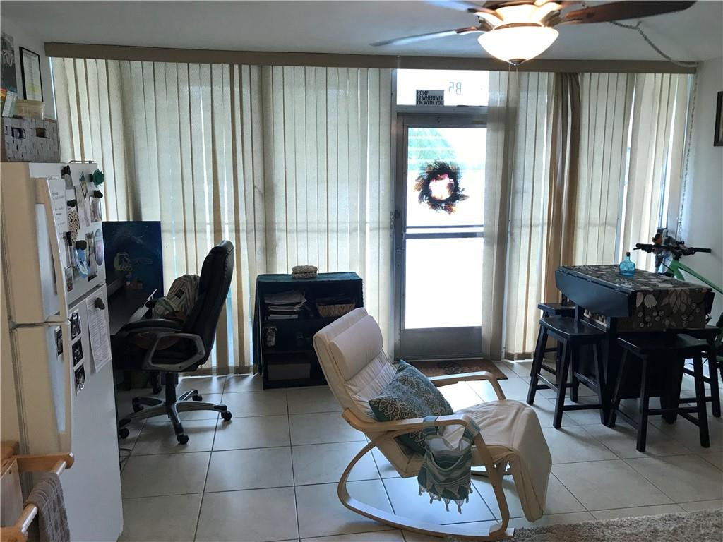 901 North Birch Road, Unit 5B Fort Lauderdale, FL 33304 - Photo 4 of 12 a view of a livingroom with workspace and a window