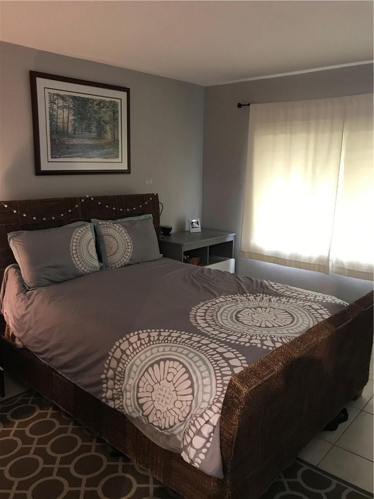 901 North Birch Road, Unit 5B Fort Lauderdale, FL 33304 - Photo 5 of 12 a bedroom with a bed and window