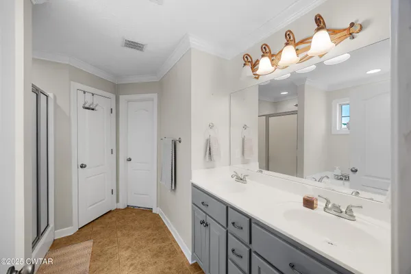 a bathroom with a sink a mirror and a light fixture