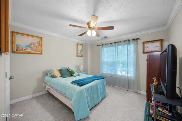 a bedroom with furniture and a flat screen tv