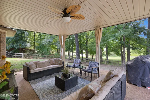 a view of patio with couches and pool