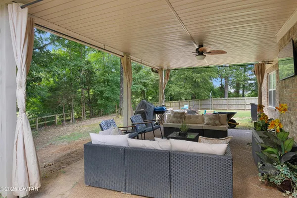 a view of a patio with a dining table and chairs