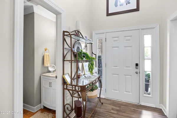 a view of an entryway with wooden floor