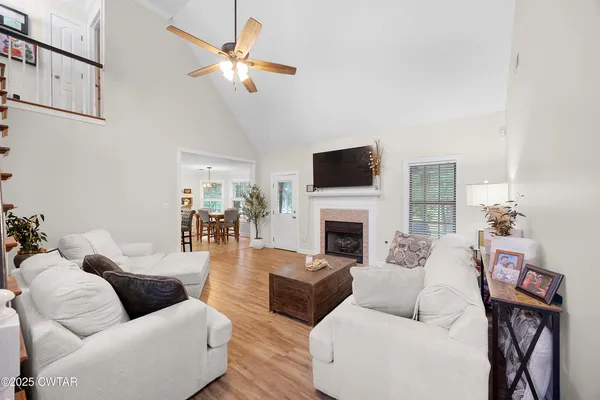 a living room with furniture a fireplace and a flat screen tv