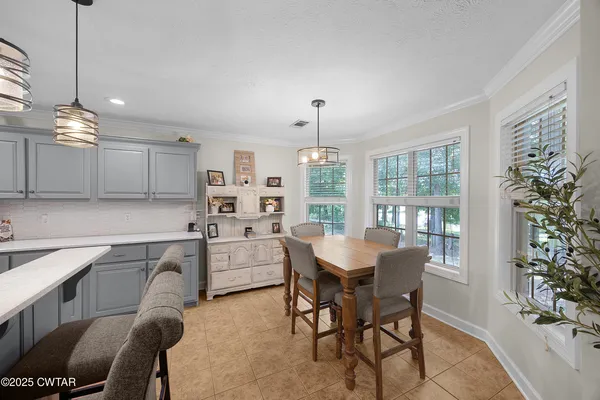 a kitchen that has a table and chairs in it