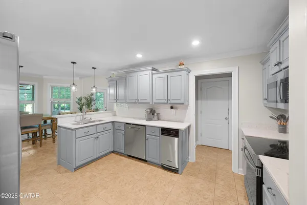 a kitchen with a sink and white cabinets