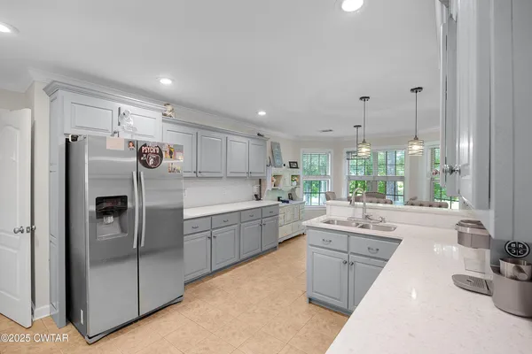 a kitchen with refrigerator and sink