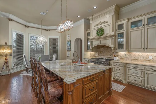 a kitchen with center island table and chairs