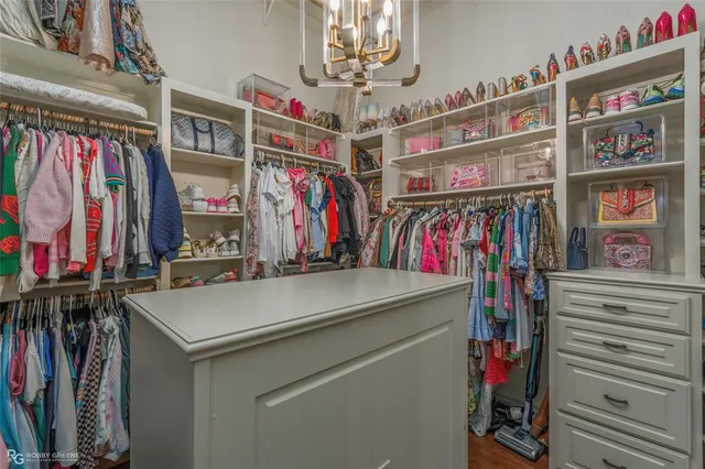 a view of walk in closet with clothes