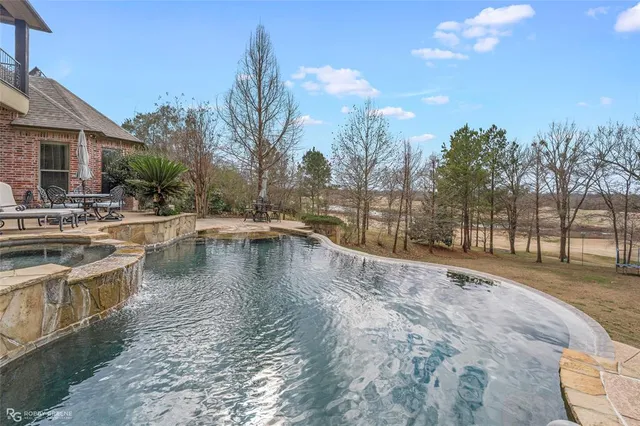 a aerial view of a house with a yard patio and swimming pool