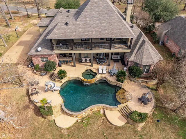 a front view of a house with a garage and a yard