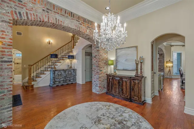 a view of a livingroom with hardwood floor and a chandelier
