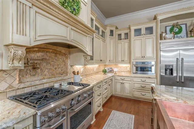a kitchen with stainless steel appliances granite countertop a stove and a sink