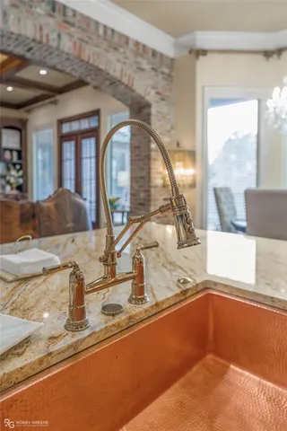 a kitchen with a sink and a mirror
