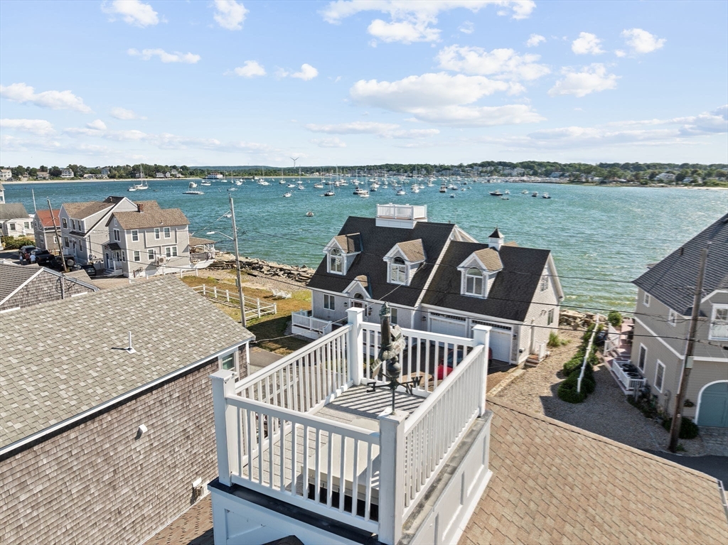 53 Lighthouse Road Scituate, MA 02066 - Photo 5 of 29 a view of a roof deck with two couches and city view
