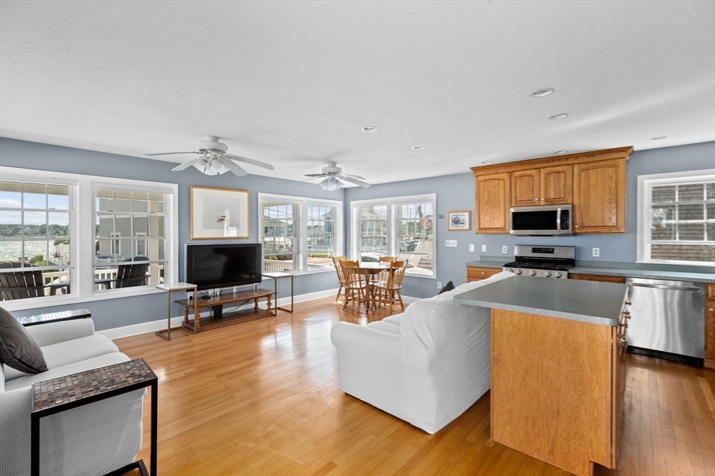53 Lighthouse Road Scituate, MA 02066 - Photo 9 of 29 a living room with fireplace furniture and a flat screen tv