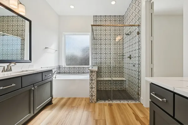 a bathroom with a shower sink and mirror