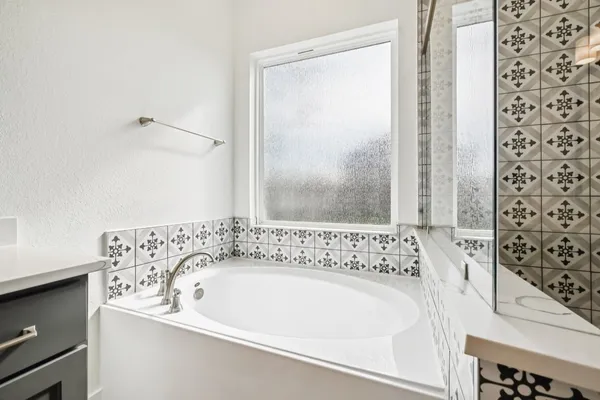 a bathroom with a bathtub and a shower