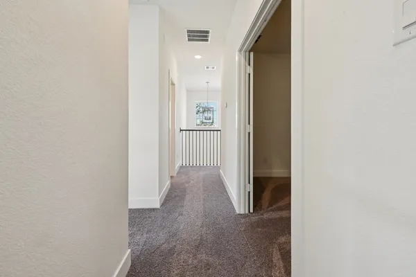 a view of a hallway with wooden walls