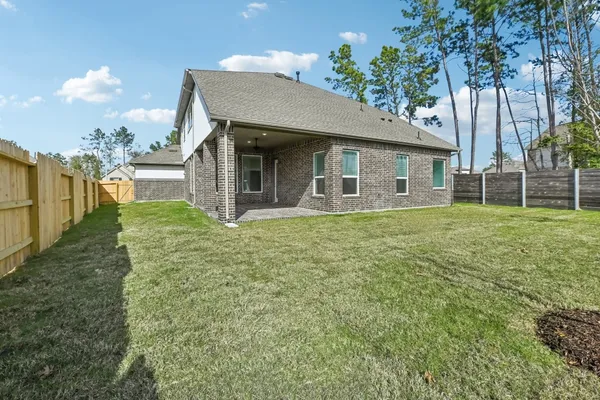 a view of a house with a yard and potted plants