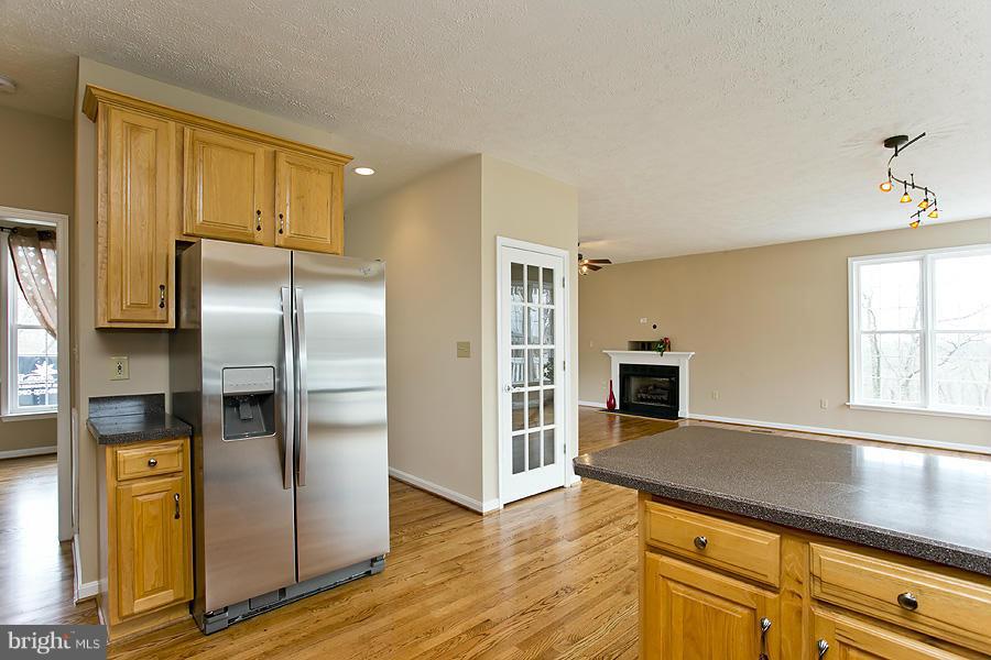 176 White Hall Road Winchester, VA 22603 - Photo 11 of 30 a kitchen with stainless steel appliances granite countertop a refrigerator a stove and a sink with cabinets