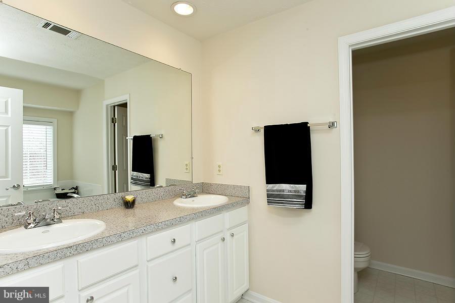 176 White Hall Road Winchester, VA 22603 - Photo 16 of 30 a bathroom with a granite countertop sink and a mirror