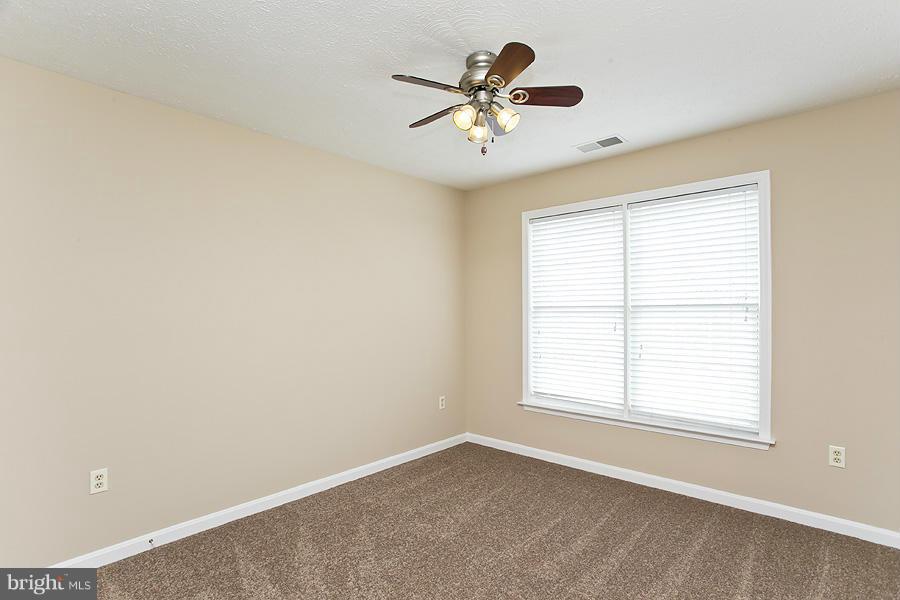 176 White Hall Road Winchester, VA 22603 - Photo 19 of 30 an empty room with a window and a fan