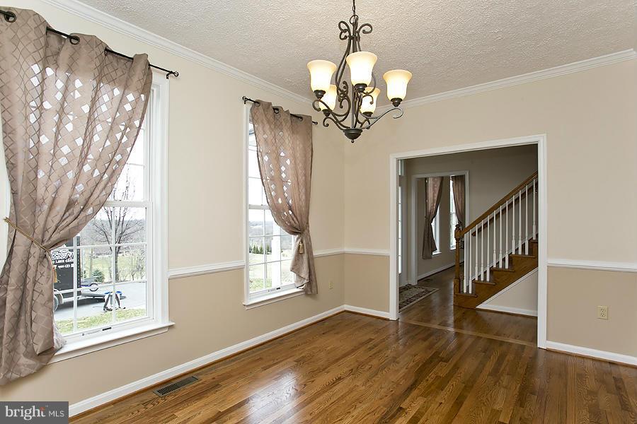 176 White Hall Road Winchester, VA 22603 - Photo 3 of 30 a view of a livingroom with wooden floor and windows