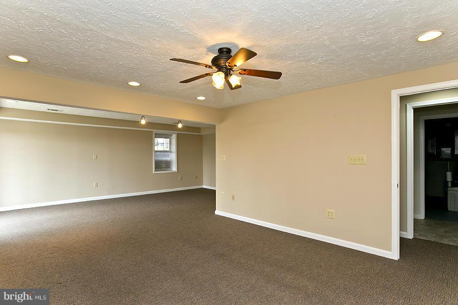 176 White Hall Road Winchester, VA 22603 - Photo 21 of 30 an empty room with windows and fan
