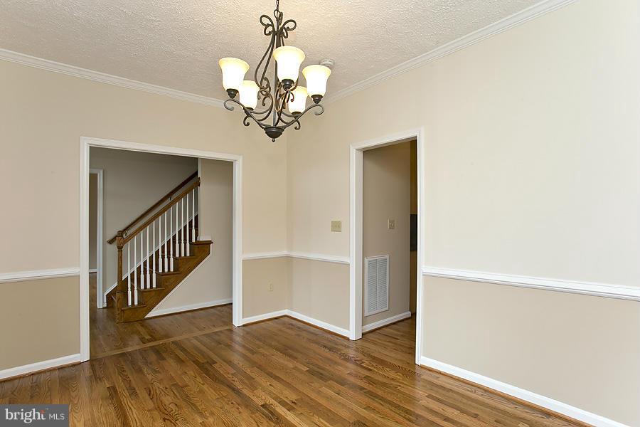 176 White Hall Road Winchester, VA 22603 - Photo 4 of 30 a view of a hallway with wooden floor and staircase