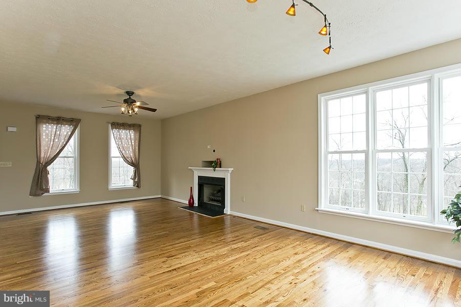 176 White Hall Road Winchester, VA 22603 - Photo 5 of 30 a view of an empty room with wooden floor and a window