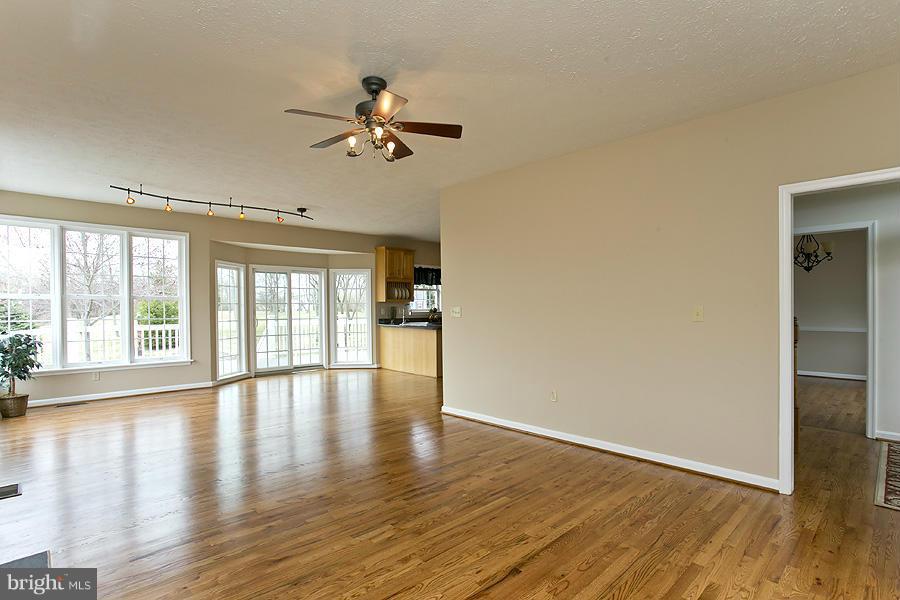 176 White Hall Road Winchester, VA 22603 - Photo 6 of 30 a view of empty room with wooden floor and fan