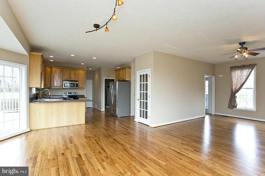 176 White Hall Road Winchester, VA 22603 - Photo 7 of 30 a view of kitchen with stainless steel appliances refrigerator stove and wooden floor