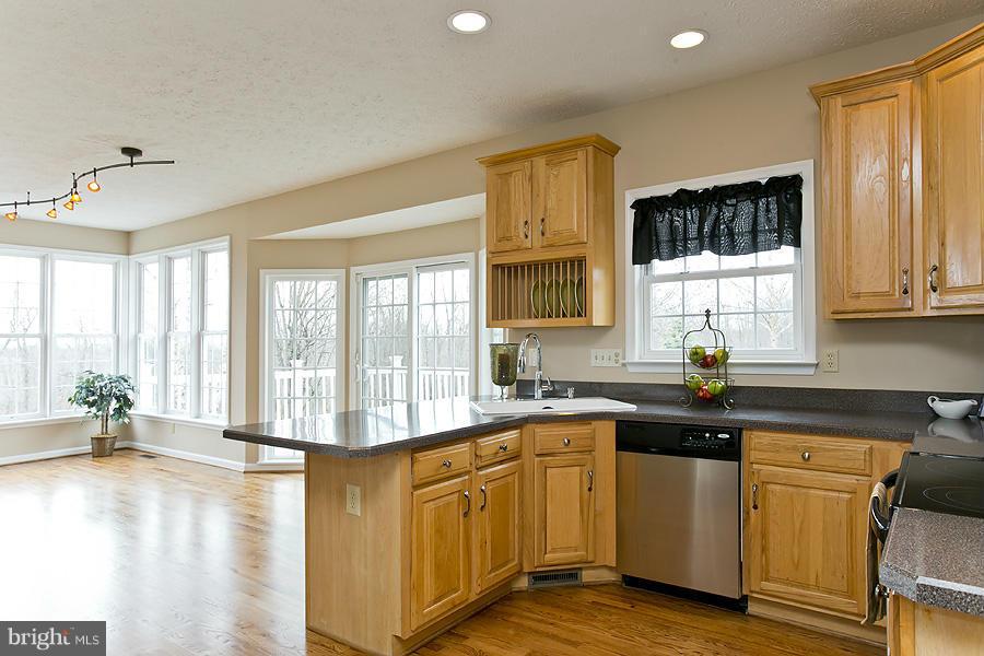 176 White Hall Road Winchester, VA 22603 - Photo 9 of 30 a kitchen with sink cabinets and wooden floor
