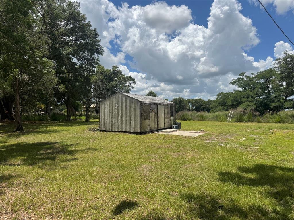 9827 Southeast Hoth Road Arcadia, FL 34266 - Photo 8 of 28 a view of a house with a yard and garage