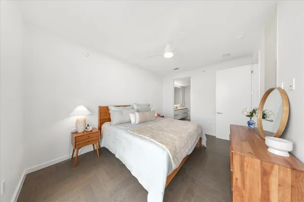 a bedroom with bed and a chandelier