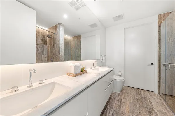 a bathroom with a double vanity sink and a mirror