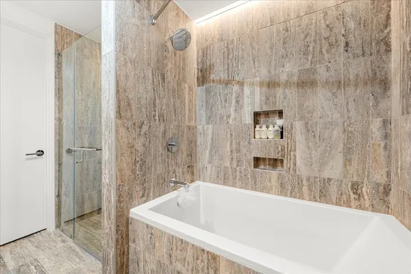 a bathroom with a tub and shower