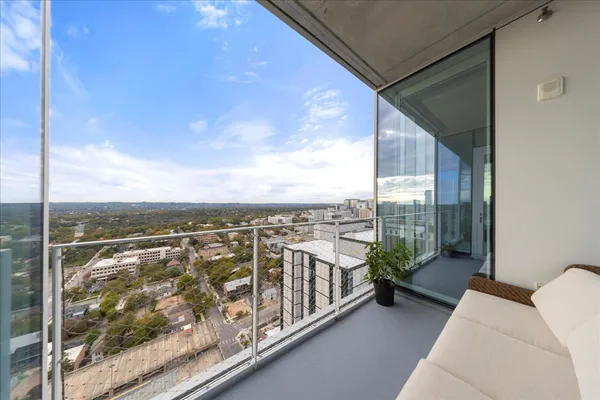 a view of a balcony with wooden floor and city view