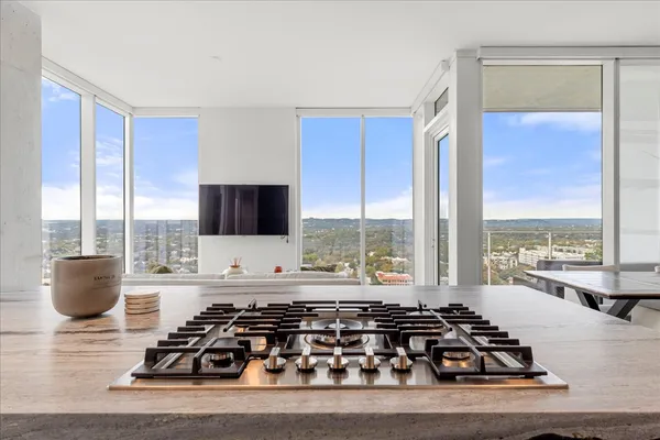 a living room with furniture and a floor to ceiling window