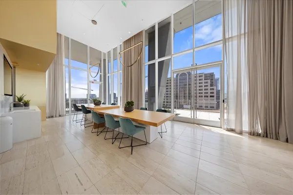 a dining room with furniture and a flat screen tv