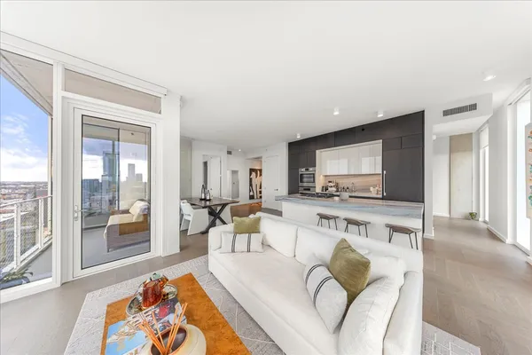 a living room with furniture fireplace and a table