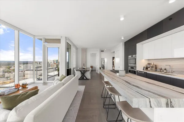 a large living room with a large window and furniture