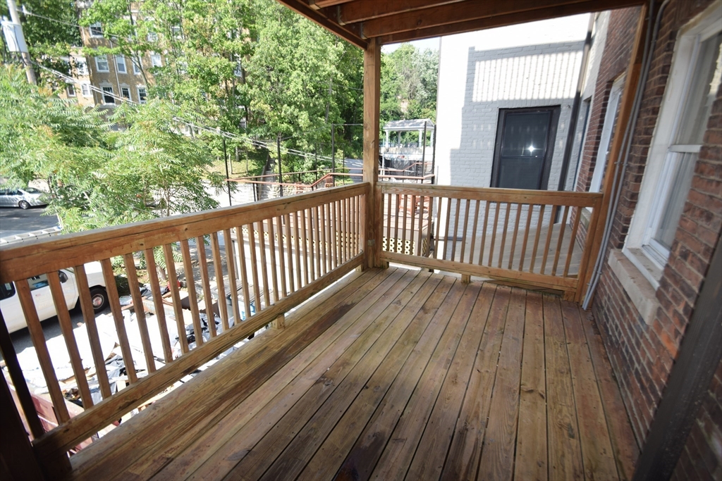1616 Beacon Street, Unit 2 Brookline, MA 02446 - Photo 6 of 9 a view of porch with wooden floor
