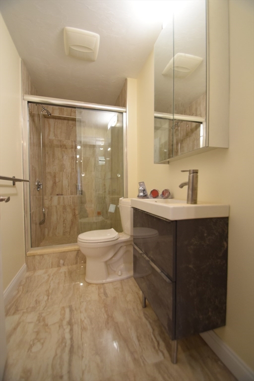 1616 Beacon Street, Unit 2 Brookline, MA 02446 - Photo 9 of 9 a bathroom with a sink a toilet and shower