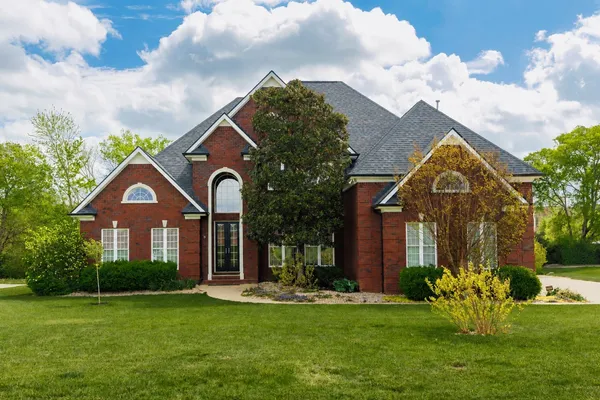 a front view of a house with garden