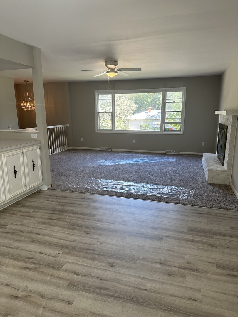 220 North Rosedale Avenue Aurora, IL 60506 - Photo 3 of 10 a view of an empty room with wooden floor and a window