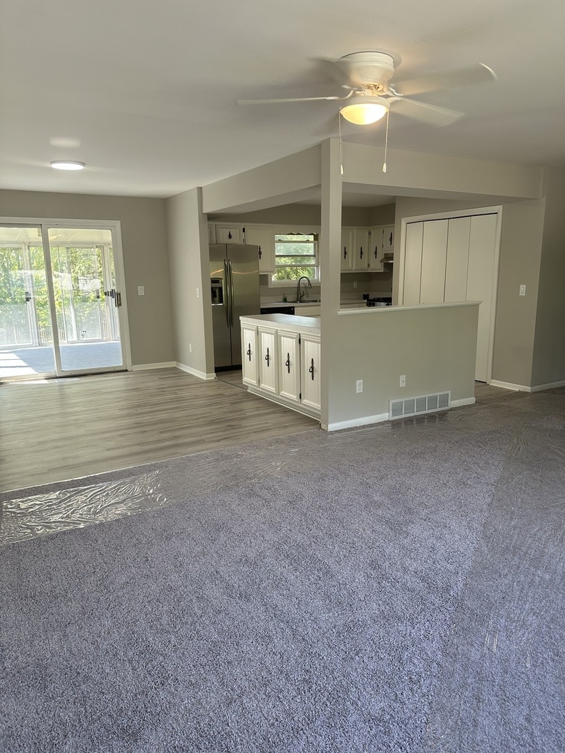 220 North Rosedale Avenue Aurora, IL 60506 - Photo 4 of 10 a view of a big room with windows and chandelier fan