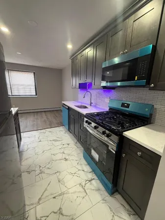 a kitchen with stainless steel appliances granite countertop a stove and a refrigerator